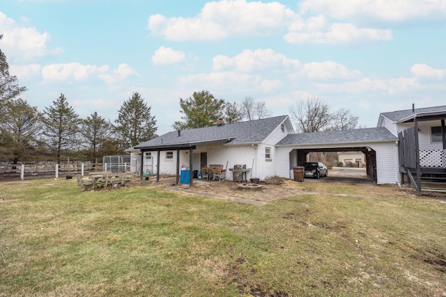 back of property featuring a lawn