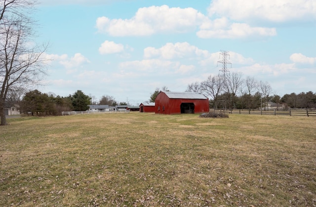 view of yard with a rural view and an outbuilding