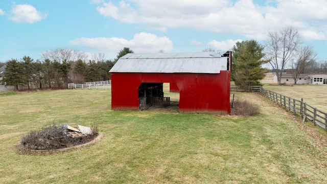 view of outdoor structure featuring a rural view and a yard