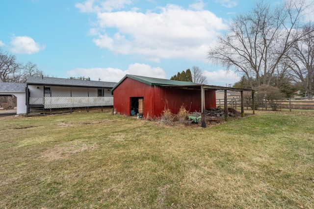 view of outbuilding featuring a lawn