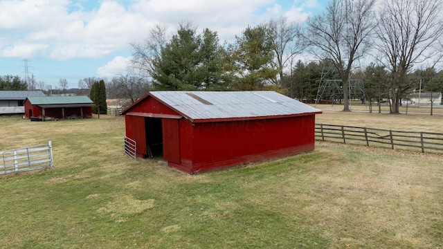 view of outdoor structure with a yard and a rural view