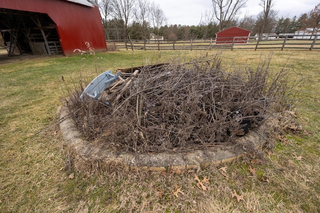 entry to storm shelter with an outdoor structure and a rural view