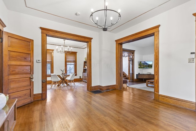 interior space featuring an inviting chandelier and wood-type flooring