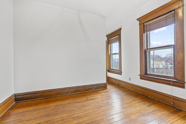 empty room with light hardwood / wood-style flooring