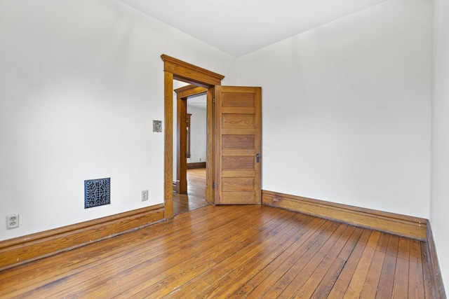 spare room with hardwood / wood-style flooring