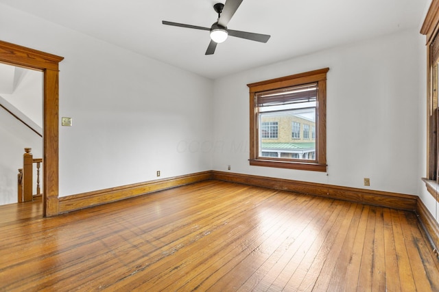 empty room with ceiling fan and wood-type flooring