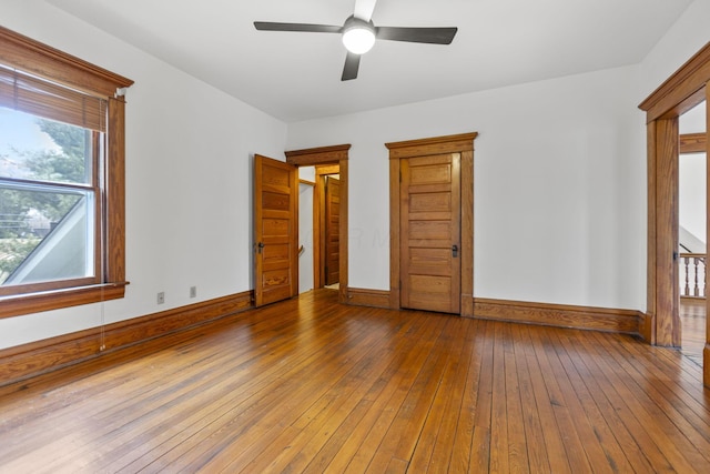 spare room featuring wood-type flooring and ceiling fan