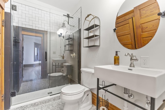 bathroom with an enclosed shower and toilet