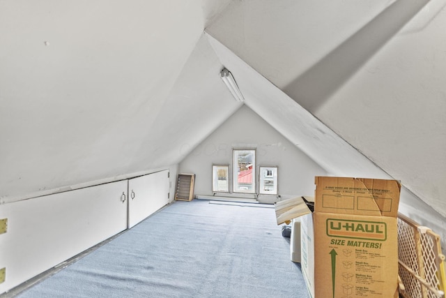 bonus room featuring vaulted ceiling and light carpet