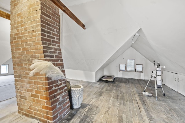 bonus room with lofted ceiling, wood-type flooring, and a healthy amount of sunlight