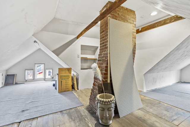 additional living space with lofted ceiling and hardwood / wood-style floors