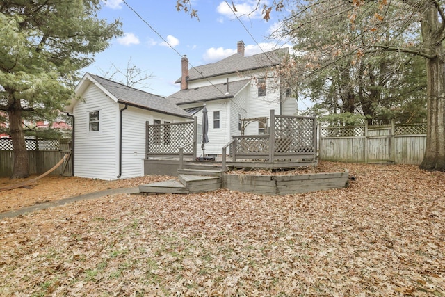 back of property with a wooden deck