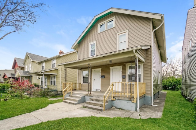 view of front of house featuring a front yard and covered porch