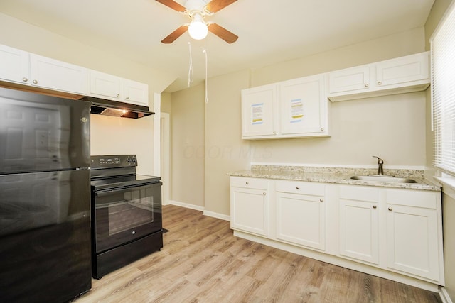 kitchen featuring white cabinetry, a sink, light wood-type flooring, under cabinet range hood, and black appliances