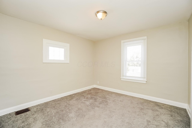 carpeted empty room with baseboards and a healthy amount of sunlight