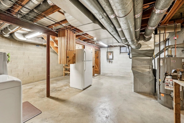 basement featuring heating unit, water heater, washer / clothes dryer, and white fridge