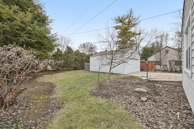 view of yard featuring a garage and an outdoor structure