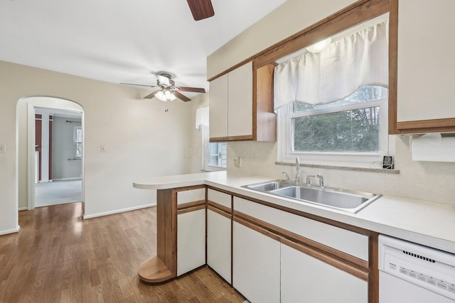 kitchen featuring sink, white cabinetry, white dishwasher, ceiling fan, and hardwood / wood-style floors