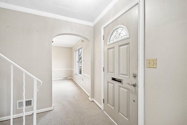 carpeted entryway with ornamental molding