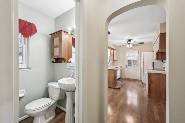 bathroom with ceiling fan, toilet, and hardwood / wood-style floors