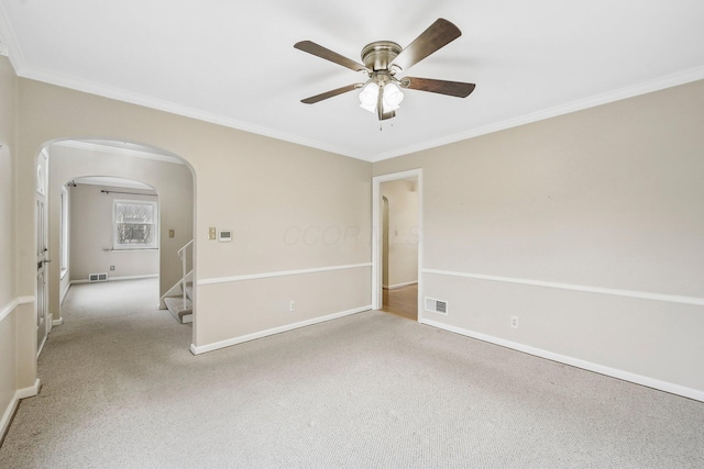 carpeted empty room with ornamental molding and ceiling fan