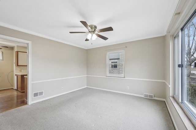 carpeted spare room with ornamental molding and ceiling fan