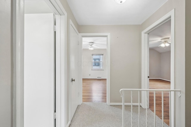 hallway featuring light colored carpet