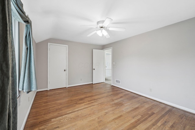 unfurnished bedroom featuring vaulted ceiling, ceiling fan, and light hardwood / wood-style floors