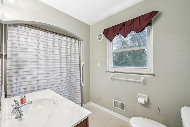 bathroom featuring vanity, toilet, and a shower with shower curtain