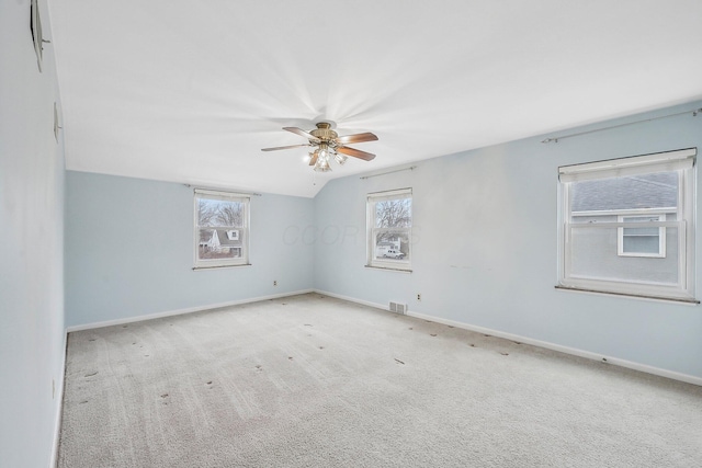 carpeted empty room with lofted ceiling and ceiling fan