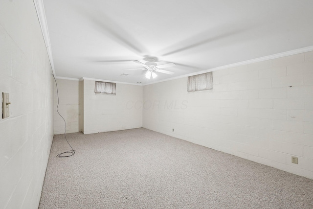 basement featuring crown molding, carpet floors, and ceiling fan