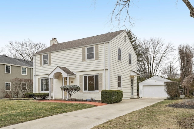 view of front facade with a garage, an outdoor structure, and a front yard