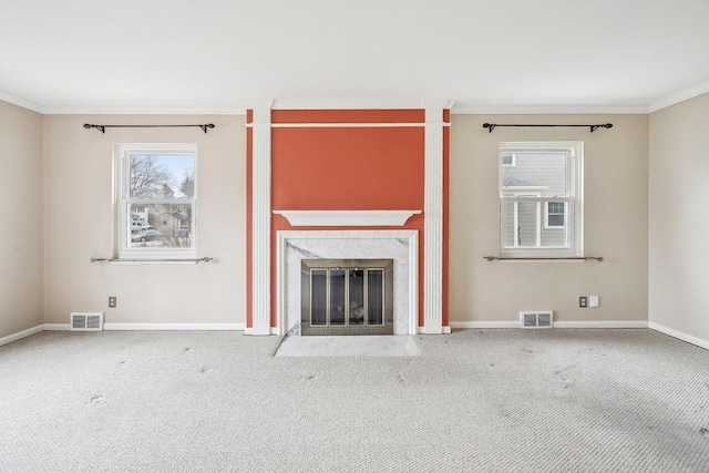 unfurnished living room with crown molding, a fireplace, and carpet flooring