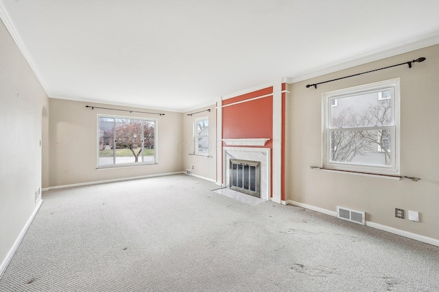 unfurnished living room featuring light colored carpet, a high end fireplace, and ornamental molding