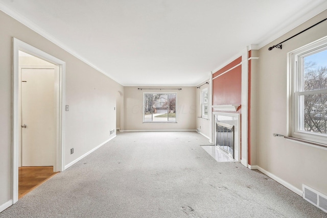 unfurnished living room with crown molding and light colored carpet