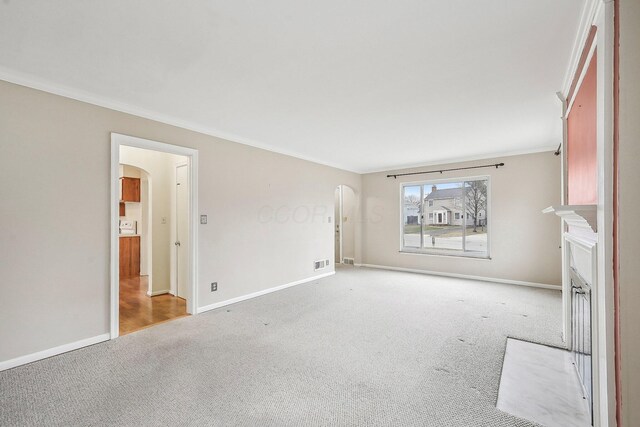 unfurnished room featuring crown molding and light colored carpet