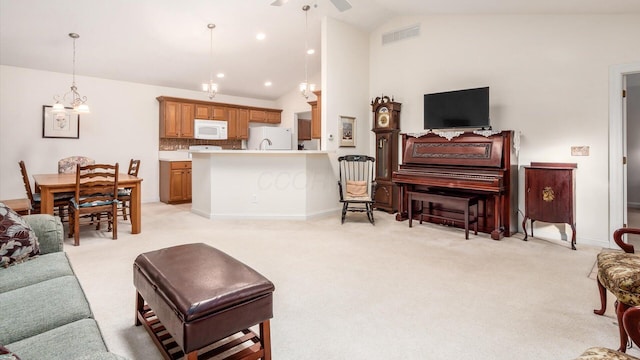 living area featuring recessed lighting, visible vents, baseboards, and light colored carpet