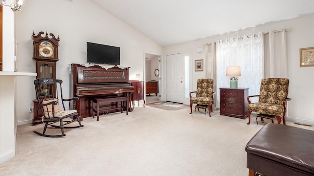 sitting room featuring lofted ceiling, carpet, and baseboards