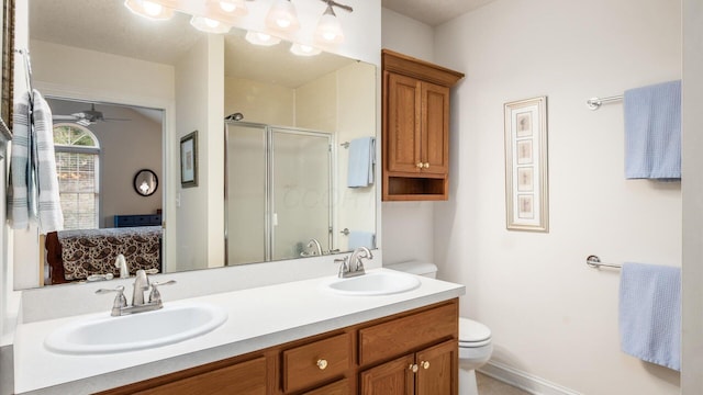 ensuite bathroom featuring toilet, ensuite bathroom, a sink, a shower stall, and double vanity