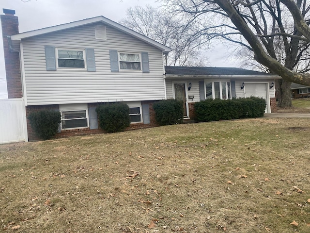 split level home featuring a garage and a front yard