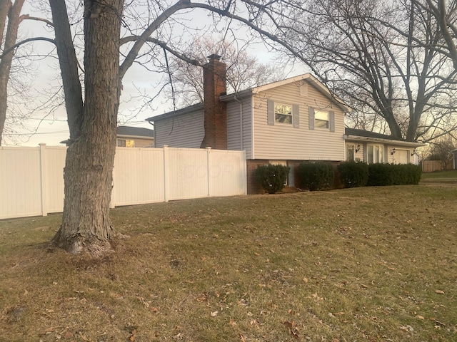 view of side of property with a lawn