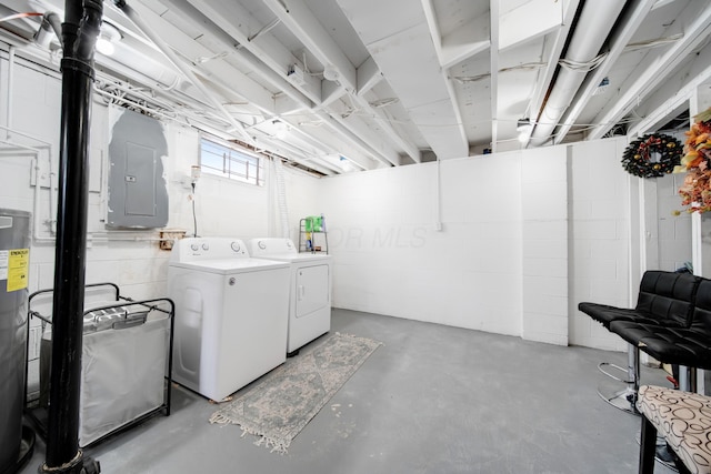 basement with electric water heater, washing machine and dryer, and electric panel