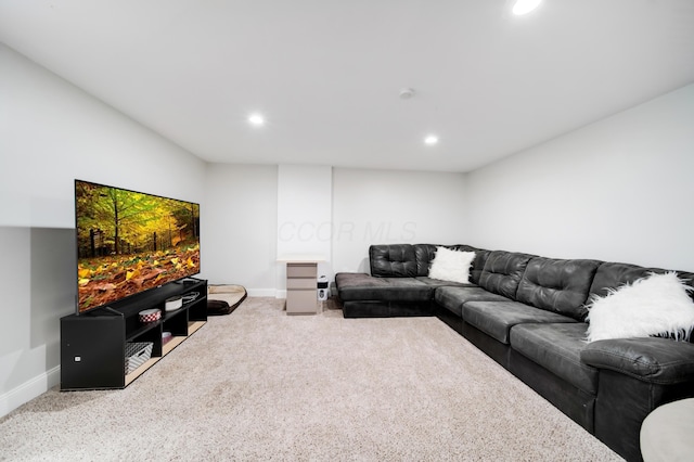 carpeted living area with baseboards and recessed lighting