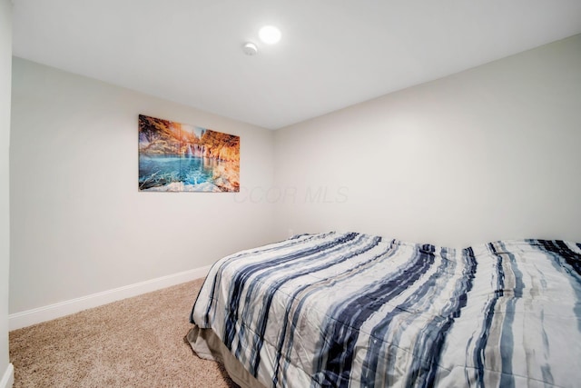 bedroom with carpet floors and baseboards