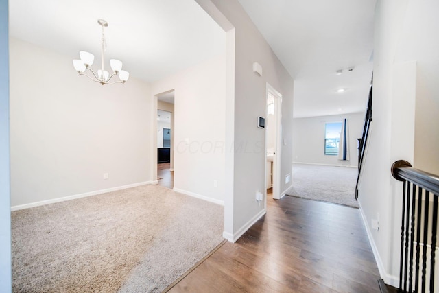 hall with a chandelier and carpet