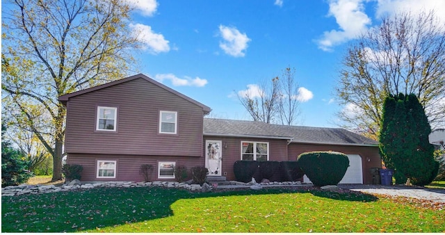 split level home with a garage and a front yard