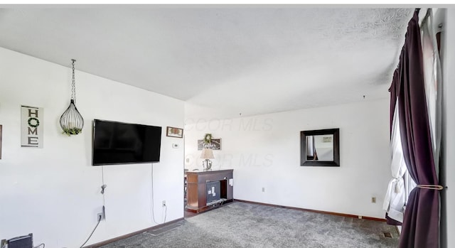 unfurnished living room featuring carpet floors