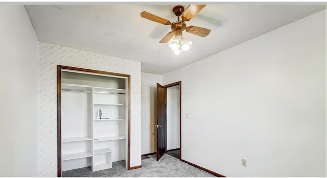 unfurnished bedroom featuring carpet flooring, ceiling fan, and a closet