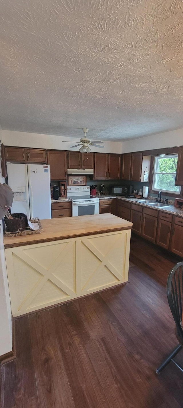 kitchen with sink, white appliances, a textured ceiling, dark hardwood / wood-style floors, and ceiling fan