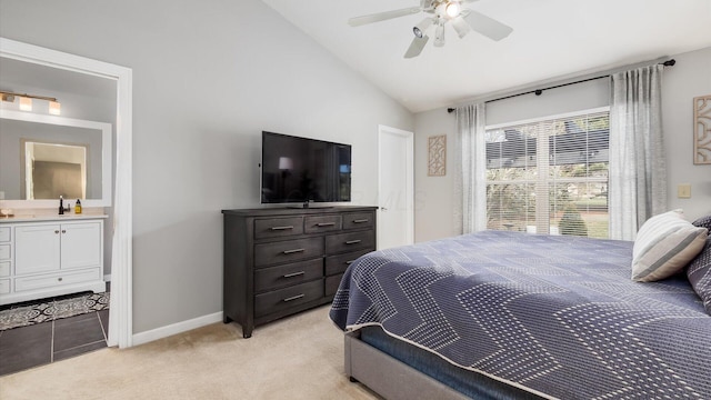 carpeted bedroom with lofted ceiling, sink, connected bathroom, and ceiling fan